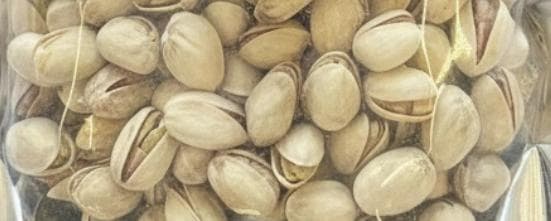 Pile of pistachio nuts, shells partly open